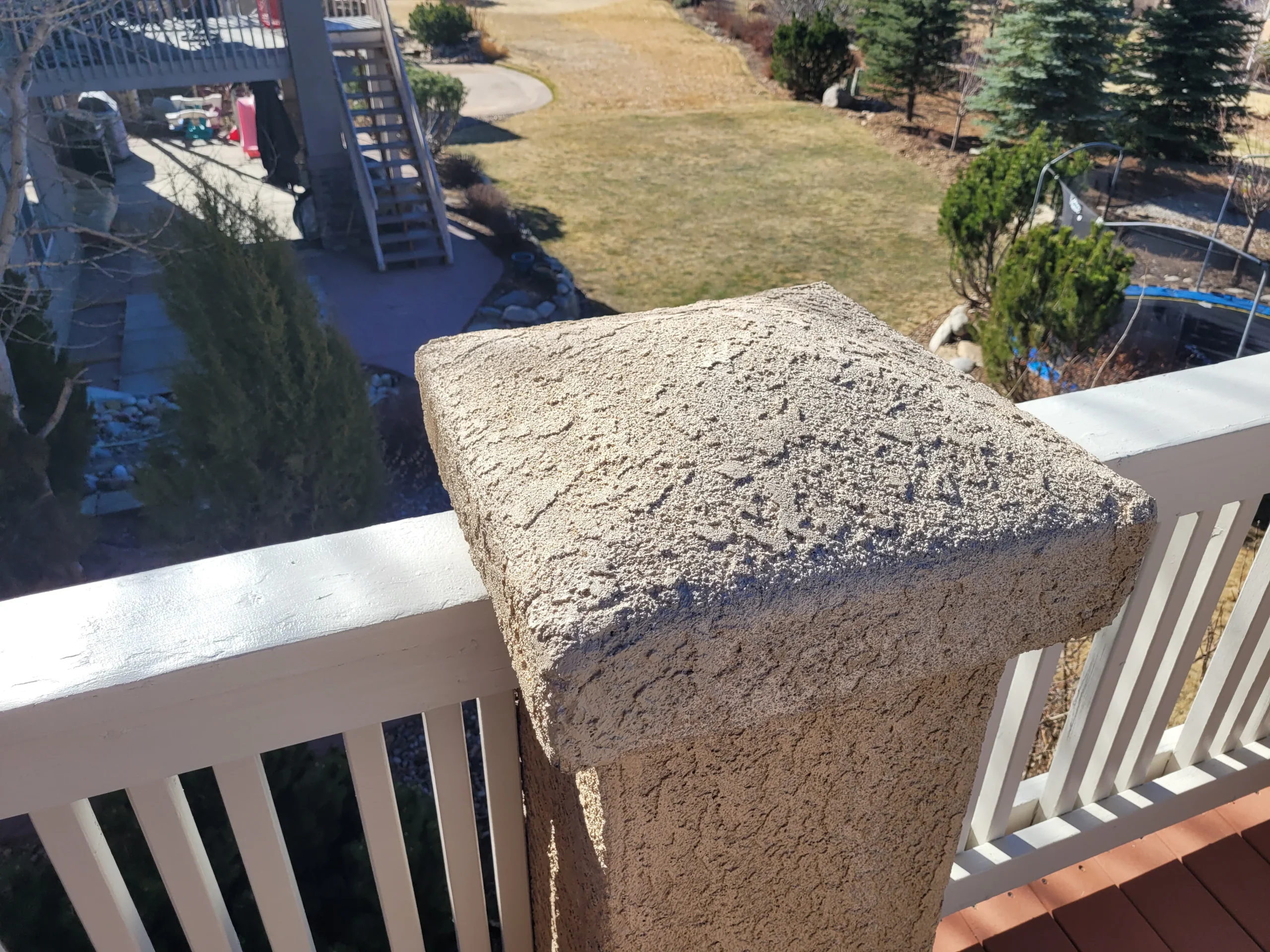 Stucco repair and paint preparation on a residential exterior