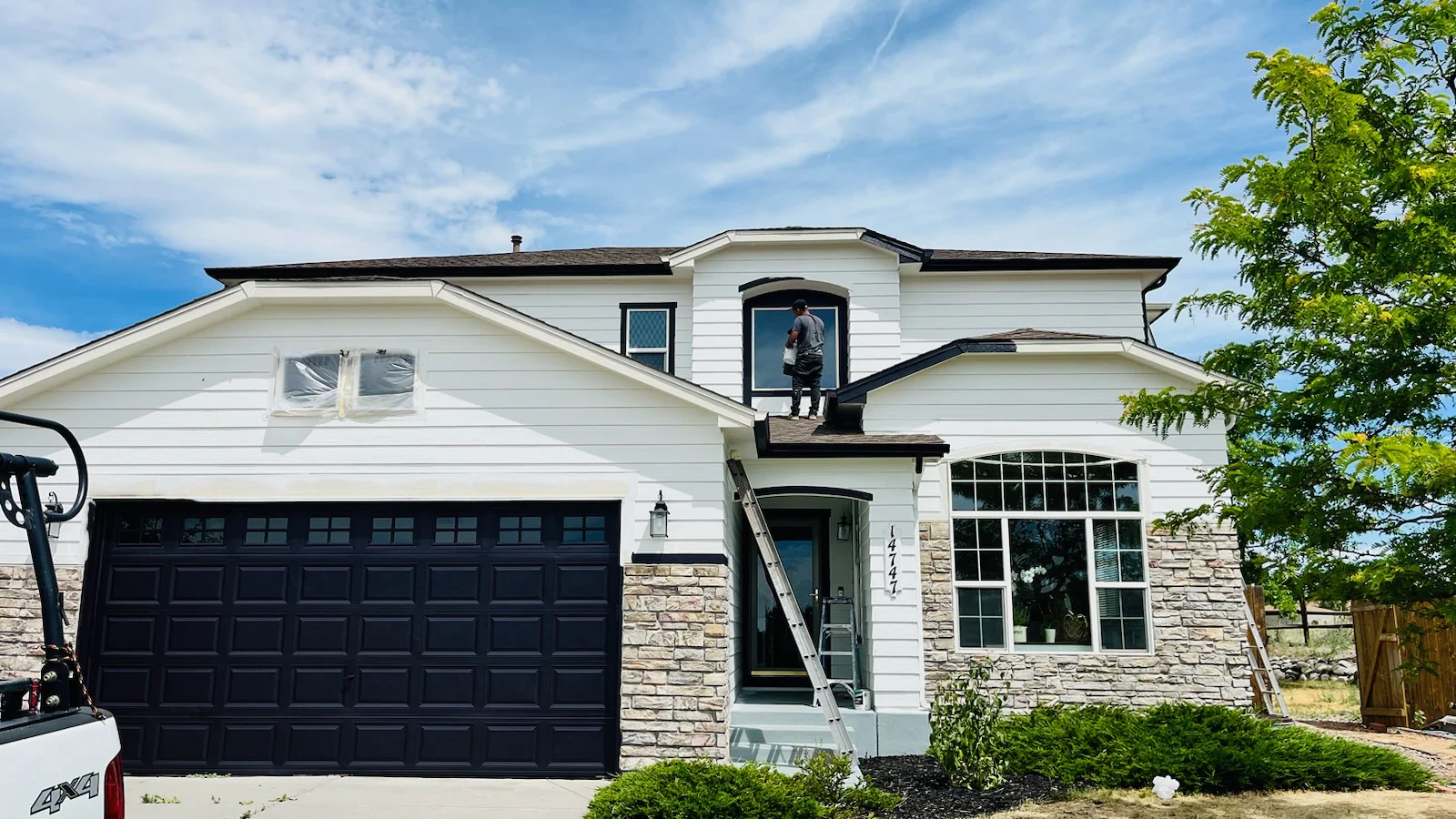 Finished Colorado Springs home exterior with white paint and contrasting trim