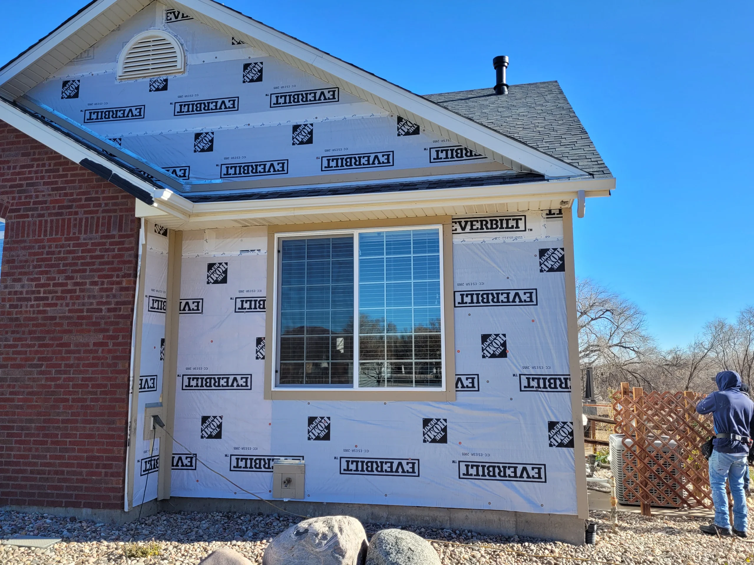 Before siding installation with moisture barrier exposed on a Colorado Springs home