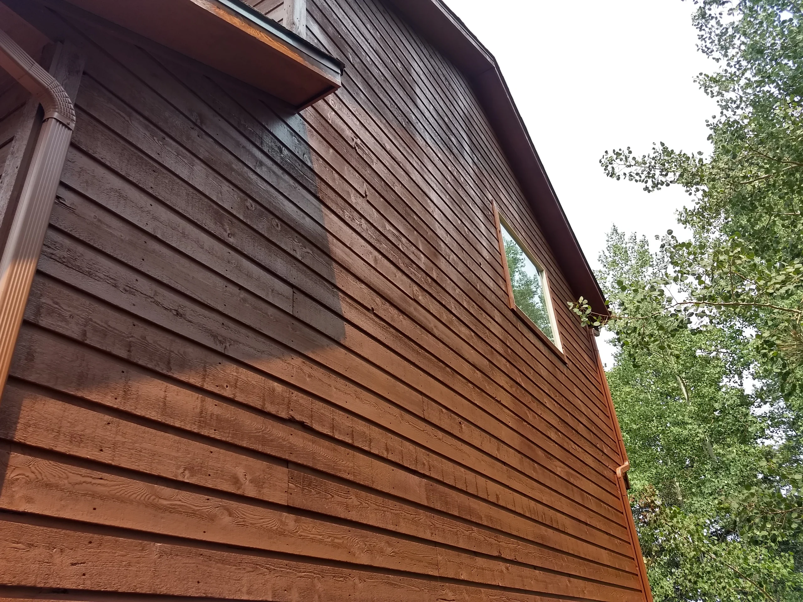 Finished exterior coating on a Colorado mountain-area home exposed to sun and weather